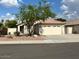 Single-story home with a two-car garage, a landscaped front yard, and a tree at 20275 N 81St Ln, Peoria, AZ 85382