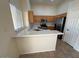 Bright kitchen with quartz countertops, wooden cabinets, and stainless steel appliances at 20275 N 81St Ln, Peoria, AZ 85382