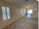 Bright living room with carpet, large windows, and chandelier lighting at 20275 N 81St Ln, Peoria, AZ 85382