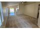 Open concept living room with carpet flooring and natural light from glass patio door at 20275 N 81St Ln, Peoria, AZ 85382