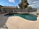 Inviting in-ground pool featuring a rock waterfall and spacious patio area, ideal for outdoor enjoyment at 20275 N 81St Ln, Peoria, AZ 85382