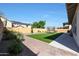 Expansive backyard featuring lush artificial turf, desert landscaping, and a trampoline for outdoor fun at 20834 W Prospector Way, Buckeye, AZ 85396