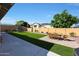A spacious backyard features a dining set, trampoline, and artificial turf, perfect for outdoor entertainment and relaxation at 20834 W Prospector Way, Buckeye, AZ 85396