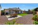 Well-maintained backyard features a dining set, artificial turf, and landscaping, creating an inviting outdoor space at 20834 W Prospector Way, Buckeye, AZ 85396