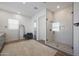Bright bathroom with a glass shower and a modern chair at 20834 W Prospector Way, Buckeye, AZ 85396