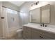 A well-lit bathroom with a modern vanity, sleek mirror, and tiled shower-tub combination, offering a clean and stylish space at 20834 W Prospector Way, Buckeye, AZ 85396