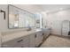 Modern bathroom with dual sinks, vanity, large mirrors, and walk-in shower at 20834 W Prospector Way, Buckeye, AZ 85396