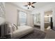 Bedroom with a ceiling fan and an ensuite bathroom with a mirrored closet at 20834 W Prospector Way, Buckeye, AZ 85396