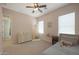 Charming bedroom with soft carpet, a ceiling fan, and natural lighting for a peaceful retreat at 20834 W Prospector Way, Buckeye, AZ 85396