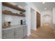 Butler pantry with open shelving and white subway tile backsplash at 20834 W Prospector Way, Buckeye, AZ 85396