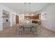Spacious dining room has wood floors, modern light fixtures, and open kitchen concept at 20834 W Prospector Way, Buckeye, AZ 85396