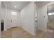 Bright entryway with light wood floors, white walls, and direct access to full bath at 20834 W Prospector Way, Buckeye, AZ 85396
