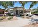 Charming home featuring mature trees, neutral stucco, stacked stone accents, and welcoming entrance at 20834 W Prospector Way, Buckeye, AZ 85396