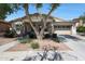 Charming home featuring mature trees, neutral stucco, stacked stone accents, and 2-car garage at 20834 W Prospector Way, Buckeye, AZ 85396