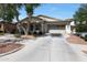 Charming home featuring mature trees, neutral stucco, stacked stone accents, and 2-car garage at 20834 W Prospector Way, Buckeye, AZ 85396