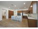 Spacious kitchen featuring wood cabinetry, a large island, and stainless steel appliances for a modern touch at 20834 W Prospector Way, Buckeye, AZ 85396