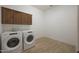 Practical laundry room with new, front-load washing machine and dryer at 20834 W Prospector Way, Buckeye, AZ 85396