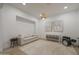 Bright living room with neutral carpet, modern lighting, and a cozy couch at 20834 W Prospector Way, Buckeye, AZ 85396