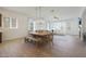 Open floor plan featuring dining area, fireplace, and large sectional sofa at 20834 W Prospector Way, Buckeye, AZ 85396