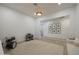 Bright living room boasts neutral walls, a modern light fixture, and a large rug over wood-look tile flooring at 20834 W Prospector Way, Buckeye, AZ 85396