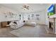 Cozy living room features a sectional sofa, fireplace, and ample natural light at 20834 W Prospector Way, Buckeye, AZ 85396