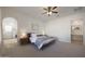 Bright main bedroom featuring neutral carpet, a ceiling fan, and neutral decor at 20834 W Prospector Way, Buckeye, AZ 85396