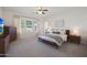 Bright main bedroom with a ceiling fan, a large window, and neutral design at 20834 W Prospector Way, Buckeye, AZ 85396
