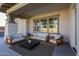 Relaxing covered patio with comfortable seating arrangements, perfect for enjoying the outdoors at 20834 W Prospector Way, Buckeye, AZ 85396