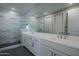 Modern bathroom featuring a spacious shower with marble-like tile and white vanity with dual sinks at 2121 W Sonoran Desert Dr # 43, Phoenix, AZ 85085