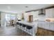 This kitchen has a large island, white cabinets, stainless steel appliances, and an adjacent dining area at 2121 W Sonoran Desert Dr # 43, Phoenix, AZ 85085