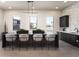 Stylish kitchen island with barstool seating, modern lighting, cabinetry, and neighborhood views at 2121 W Sonoran Desert Dr # 43, Phoenix, AZ 85085