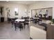 Cozy residents' lounge features tables and chairs and a view to an outdoor patio and bar at 2121 W Sonoran Desert Dr # 43, Phoenix, AZ 85085