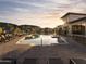Beautiful community pool surrounded by lounge chairs, mature trees, and with sunset background at 2121 W Sonoran Desert Dr # 43, Phoenix, AZ 85085