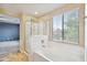 The primary bathroom has a shower, tub, and a window overlooking the yard at 2323 W Hunter Ct, Phoenix, AZ 85085