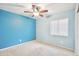 Cozy bedroom with a ceiling fan, carpeted floor, and window for natural light at 2323 W Hunter Ct, Phoenix, AZ 85085