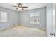 This carpeted bedroom has overhead lighting and two windows at 2323 W Hunter Ct, Phoenix, AZ 85085