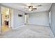 This bedroom has grey carpet, an overhead fan and neutral paint at 2323 W Hunter Ct, Phoenix, AZ 85085