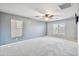 This bedroom has grey carpet, an overhead fan and neutral paint at 2323 W Hunter Ct, Phoenix, AZ 85085