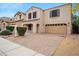Charming two-story home with a two-car garage and a well-manicured front yard at 2323 W Hunter Ct, Phoenix, AZ 85085