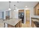 Spacious kitchen with dark wood cabinets and a center island at 2323 W Hunter Ct, Phoenix, AZ 85085