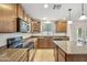 Spacious kitchen with dark wood cabinets and a center island at 2323 W Hunter Ct, Phoenix, AZ 85085
