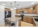 Spacious kitchen with dark wood cabinets and a center island at 2323 W Hunter Ct, Phoenix, AZ 85085