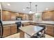 Spacious kitchen with dark wood cabinets and a center island at 2323 W Hunter Ct, Phoenix, AZ 85085
