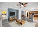 Bright living room featuring modern decor, tile flooring, and an open layout to the kitchen at 2323 W Hunter Ct, Phoenix, AZ 85085