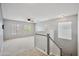 The upstairs loft space has carpet, many windows, and an overhead fan at 2323 W Hunter Ct, Phoenix, AZ 85085