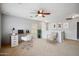 Spacious loft area featuring a ceiling fan, and a desk, creating an ideal space for work or relaxation at 2323 W Hunter Ct, Phoenix, AZ 85085