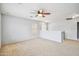This carpeted loft space is brightly lit and has an overhead fan at 2323 W Hunter Ct, Phoenix, AZ 85085