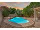 Inviting pool surrounded by lush landscaping, patio, and a rock waterfall feature at 2323 W Hunter Ct, Phoenix, AZ 85085