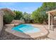 Inviting pool surrounded by lush landscaping, patio, and a rock waterfall feature at 2323 W Hunter Ct, Phoenix, AZ 85085