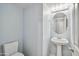 This powder room features light blue walls, a pedestal sink, and a toilet at 2323 W Hunter Ct, Phoenix, AZ 85085